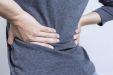 Почему от тяжести болит спина
